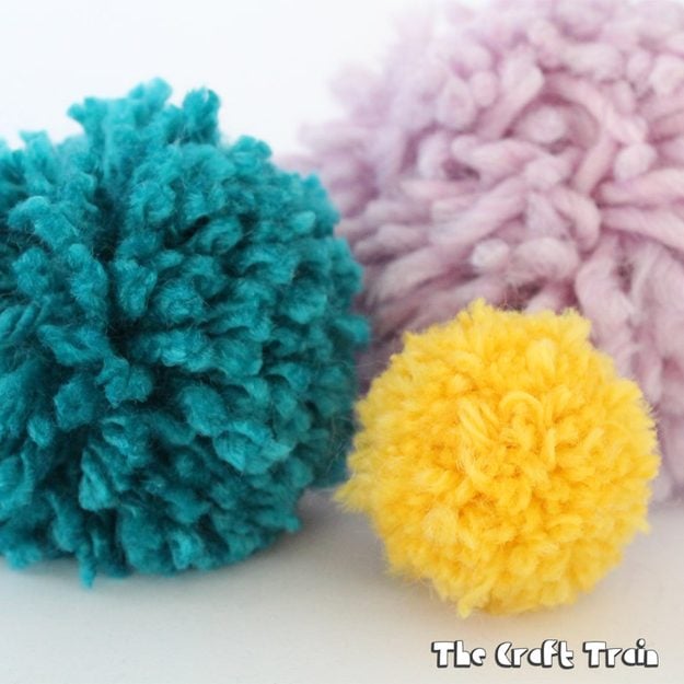 Cardboard pom pom maker built to wrap yarn into plump store bought looking pom poms at home for the whole family