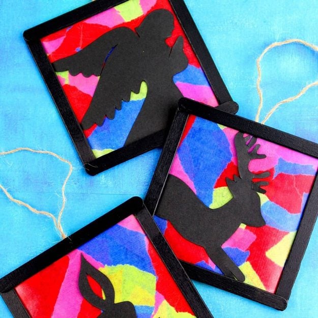 Easy DIY project: stained glass style ornaments framed in popsicle sticks around colored tissue paper