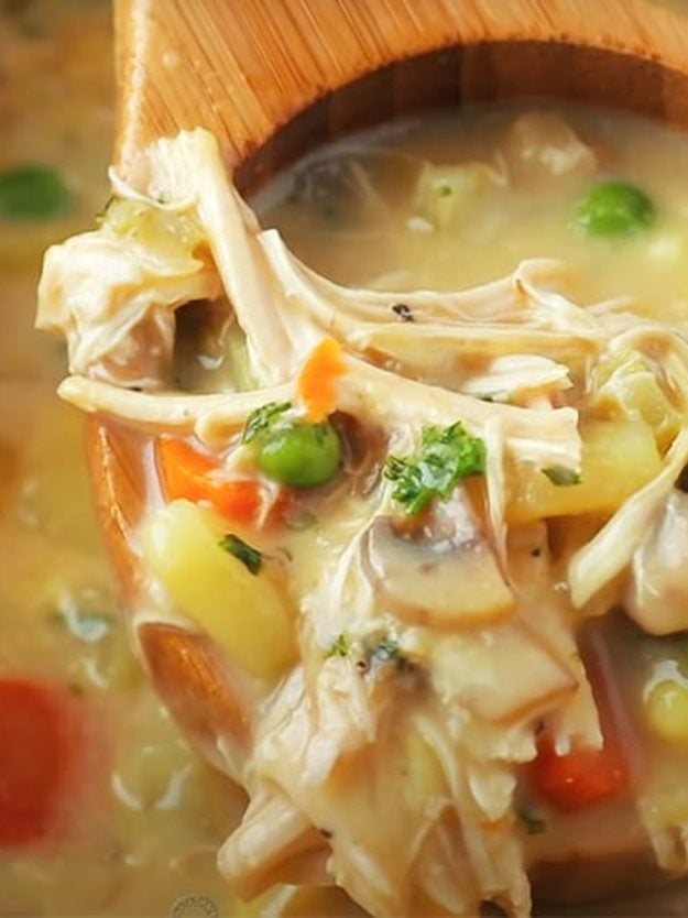 One Pot Chicken Pot Pie Recipe From DIY JOY One pot chicken pot pie being ladled from the pot, thick and creamy with shredded chicken, peas and carrot