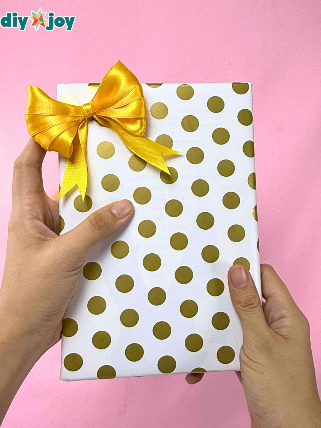 Short Paper Gift Wrapping Hack A gift wrapped on the diagonal with a short leftover piece of paper so the seams meet neatly across the top
