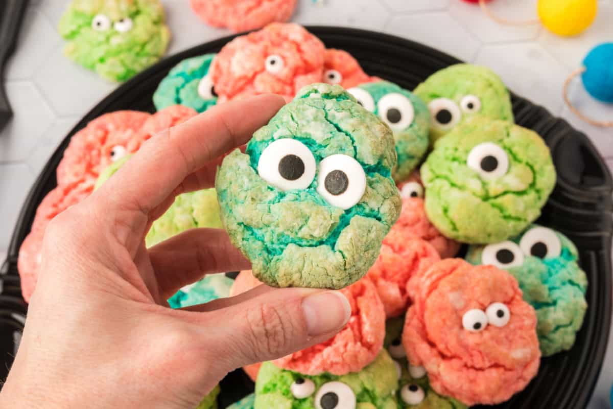 Colorful Monster Eye Halloween Cookies Halloween cookie platter with colorful monster eye cookies dotted with candy eyes in bright orange, green and purple
