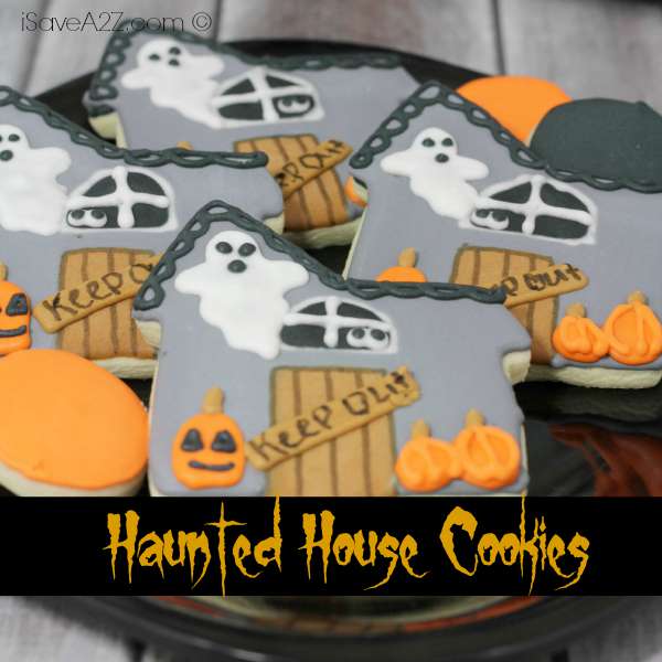 Chocolate Haunted House Cutout Cookies House-shaped Halloween cookies decorated with colorful icing ghosts, windows, pumpkins and a retained source watermark