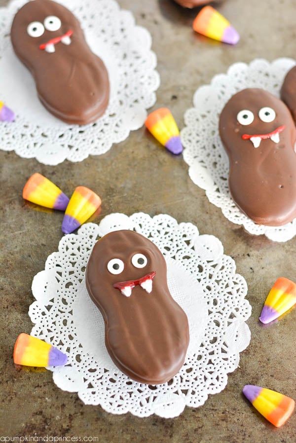 Chocolate-Dipped Vampire Nutter Butter Cookies Chocolate-dipped Nutter Butter vampire cookies with candy eyes, red gel mouths and white teeth for Halloween