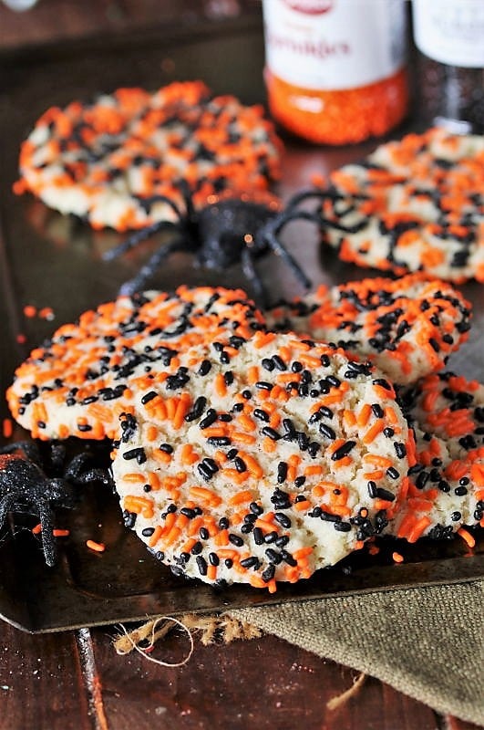 Halloween Sprinkle Sugar Cookies Soft sugar cookies rolled in orange, black, purple and green Halloween sprinkles before baking on a tray