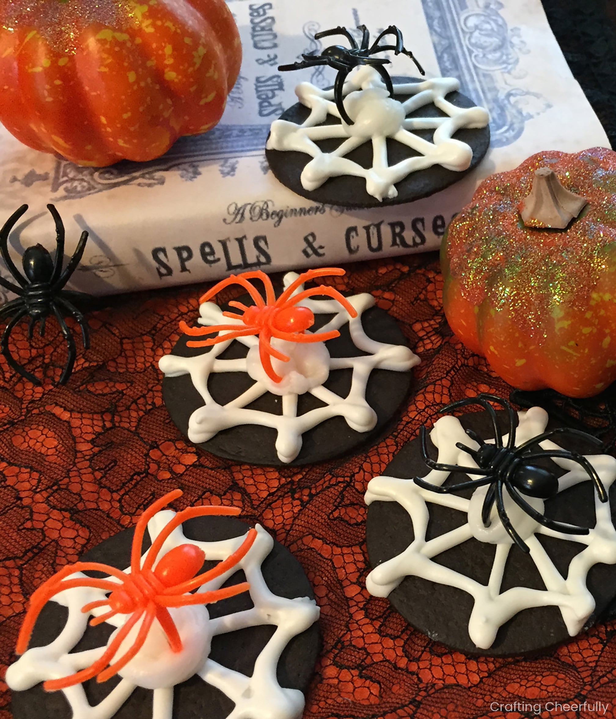 Black and White Spiderweb Cookies Chocolate wafer cookies with white piped spiderwebs and removable plastic spider rings on a Halloween platter
