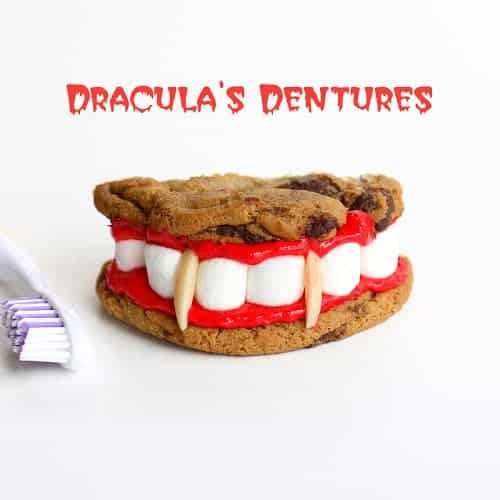 Dracula Denture Cookie Sandwiches Chocolate chip cookie sandwiches with red frosting, mini marshmallow teeth and almond vampire fangs for Halloween