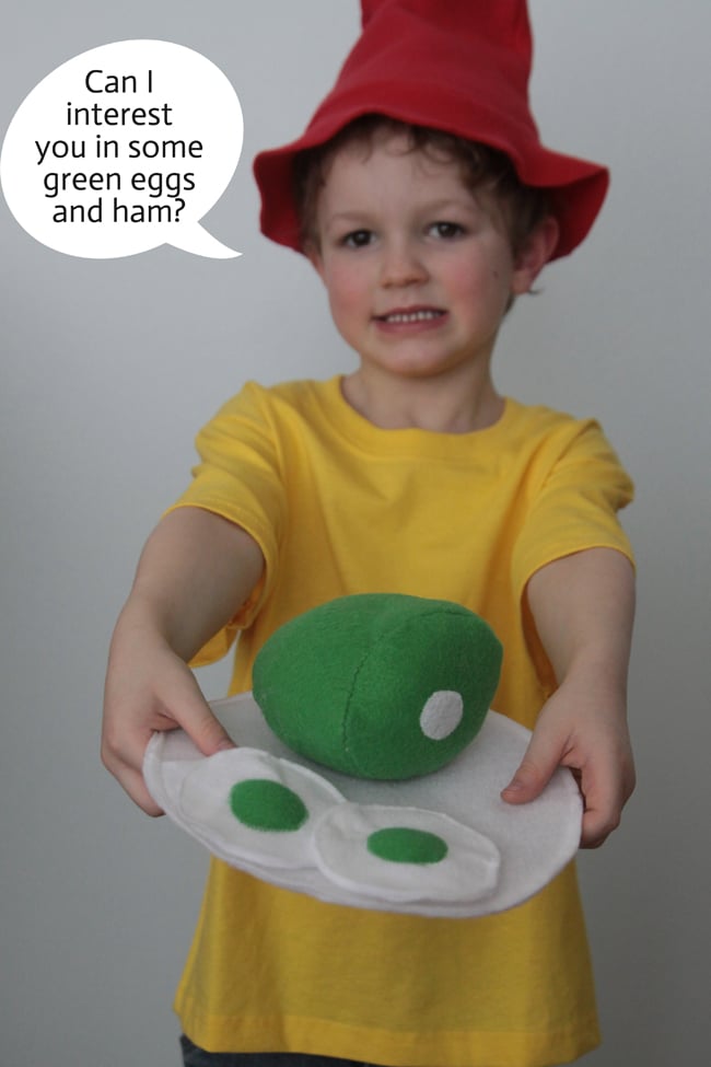 Green Eggs and Ham Costume Idea Child wearing a Green Eggs and Ham costume with a red floppy hat, yellow shirt and handmade felt plate