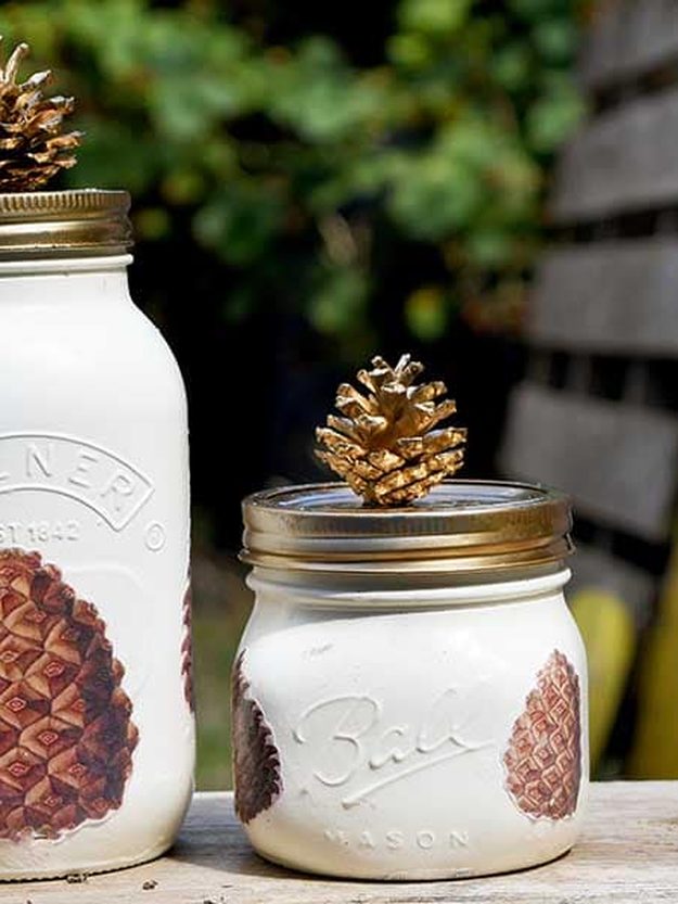 Pine Cone Decoupage Fall Mason Jars Cream painted mason jars decoupaged with vintage pine cone images, one topped with a small gold pine cone
