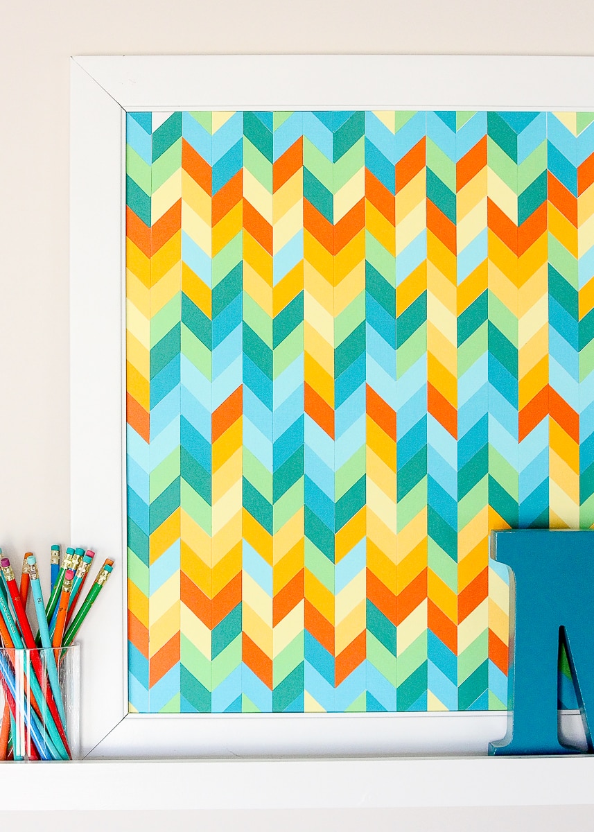 Framed chevron paper wall art in orange, blue and green cardstock, a colorful DIY bedroom wall decor idea