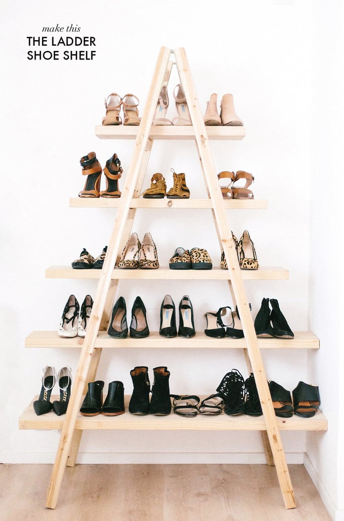 Ladder shoe shelf, a pine A frame ladder with three plank shelves of heels, sandals and boots against a white wall