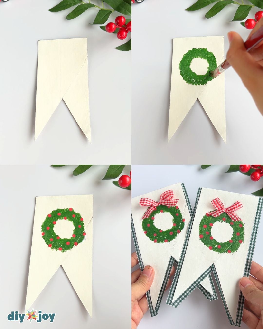White pennant painted with a green wreath, red berries and a small bow for a toilet paper roll Christmas banner centerpiece