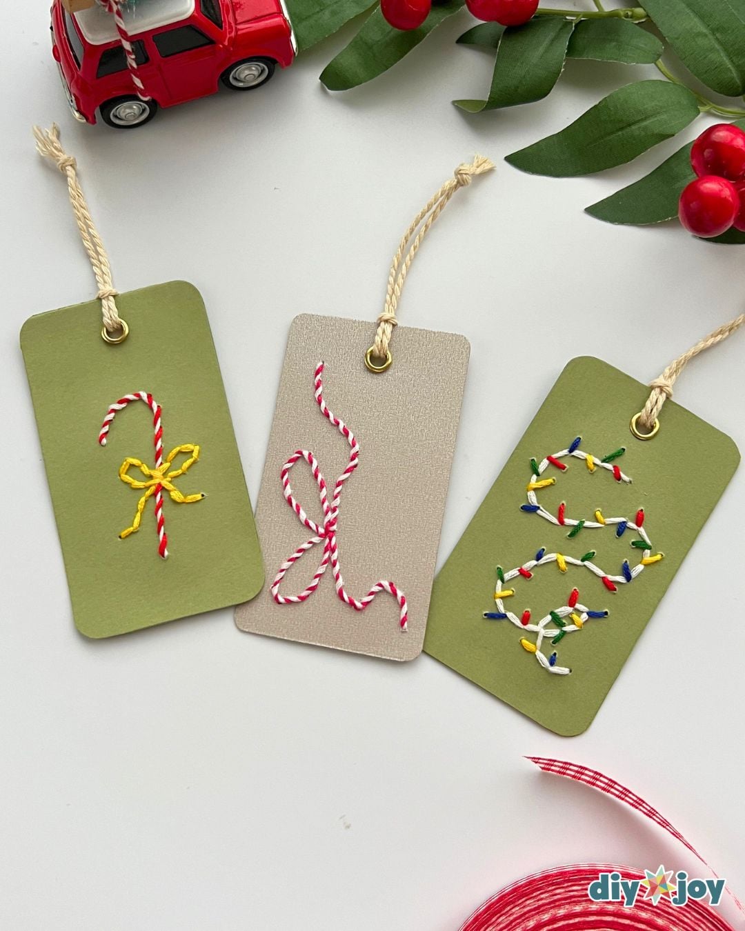 Cute gift tags for Christmas - candy cane, bow and lights embroidered tags beside a toy car and holly