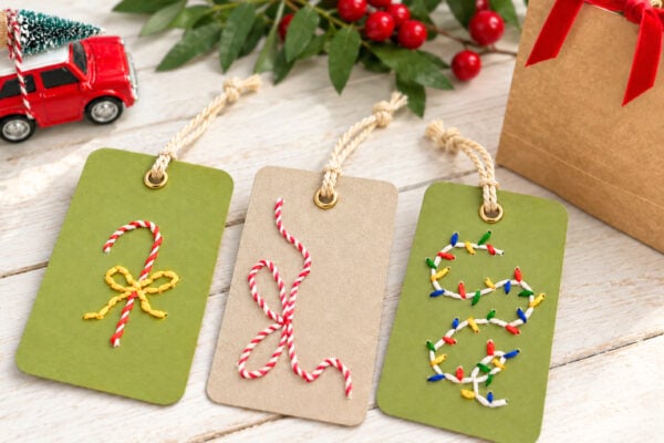 Embroidered Christmas gift tags - three green and kraft cardstock tags stitched with candy cane and lights designs
