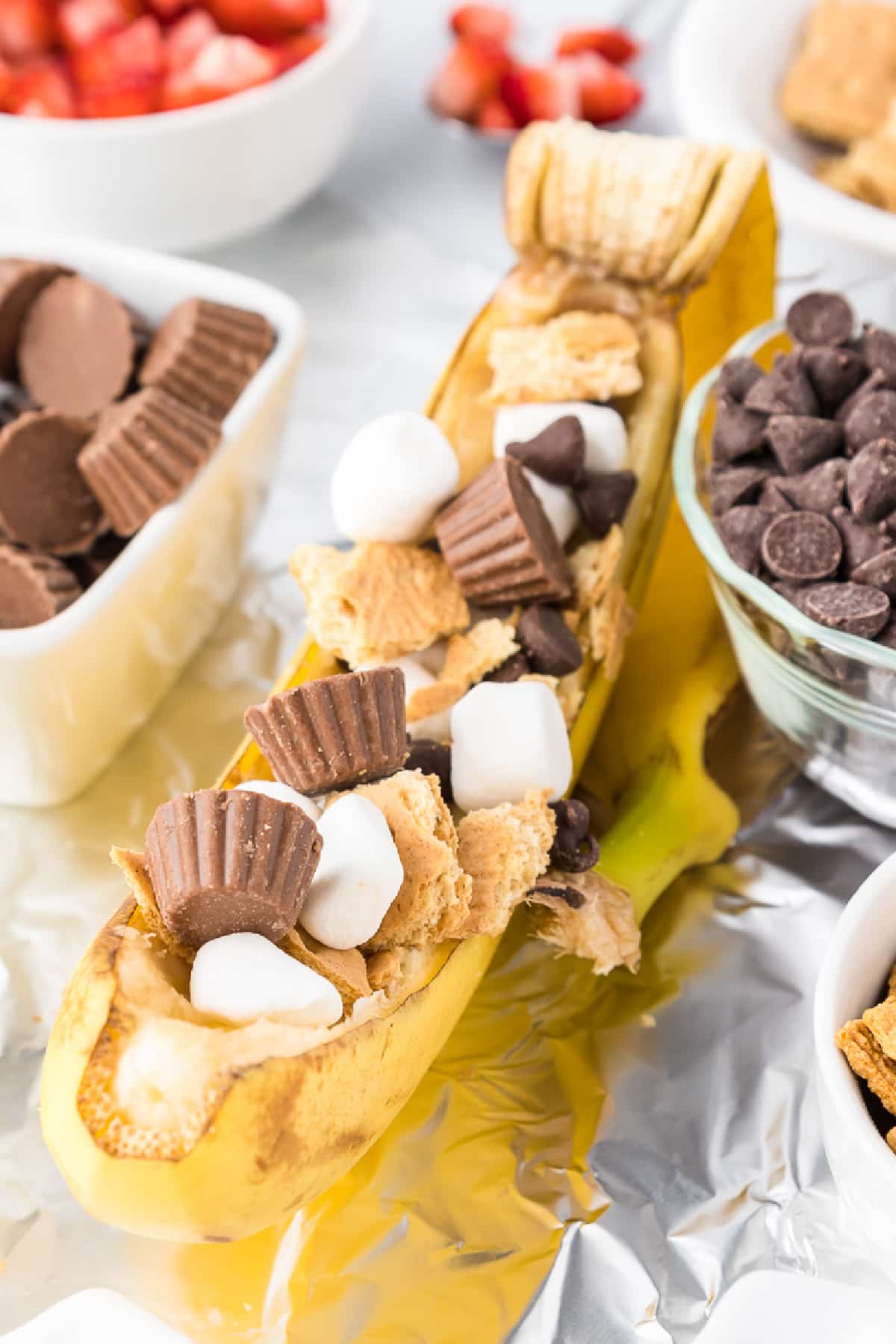 Banana boat split in its peel and stuffed with peanut butter cups, mini marshmallows and graham crackers