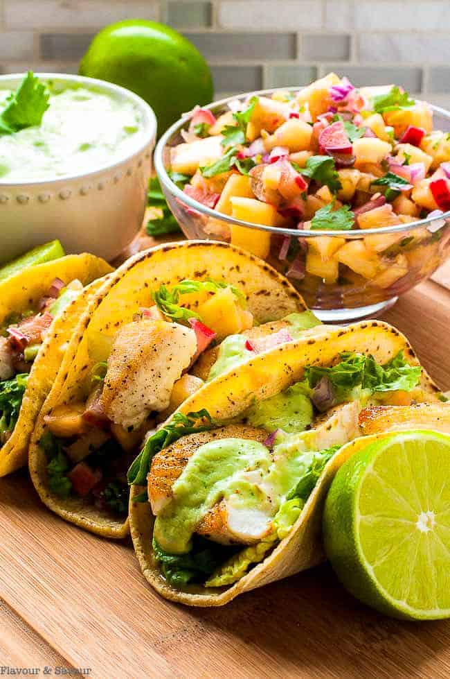 Grilled Fish Tacos with Pineapple Rhubarb Salsa Grilled fish tacos in corn tortillas with pineapple rhubarb salsa, avocado cream and lime wedges