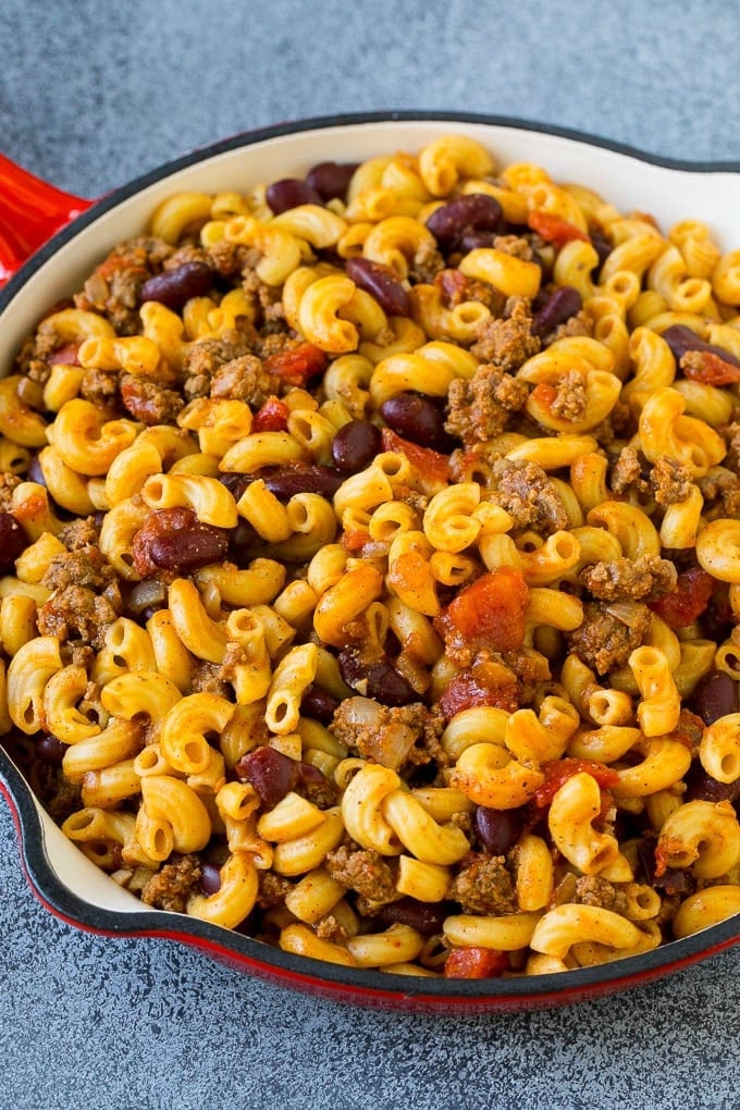 Red skillet of chili mac with corkscrew pasta, ground beef and kidney beans