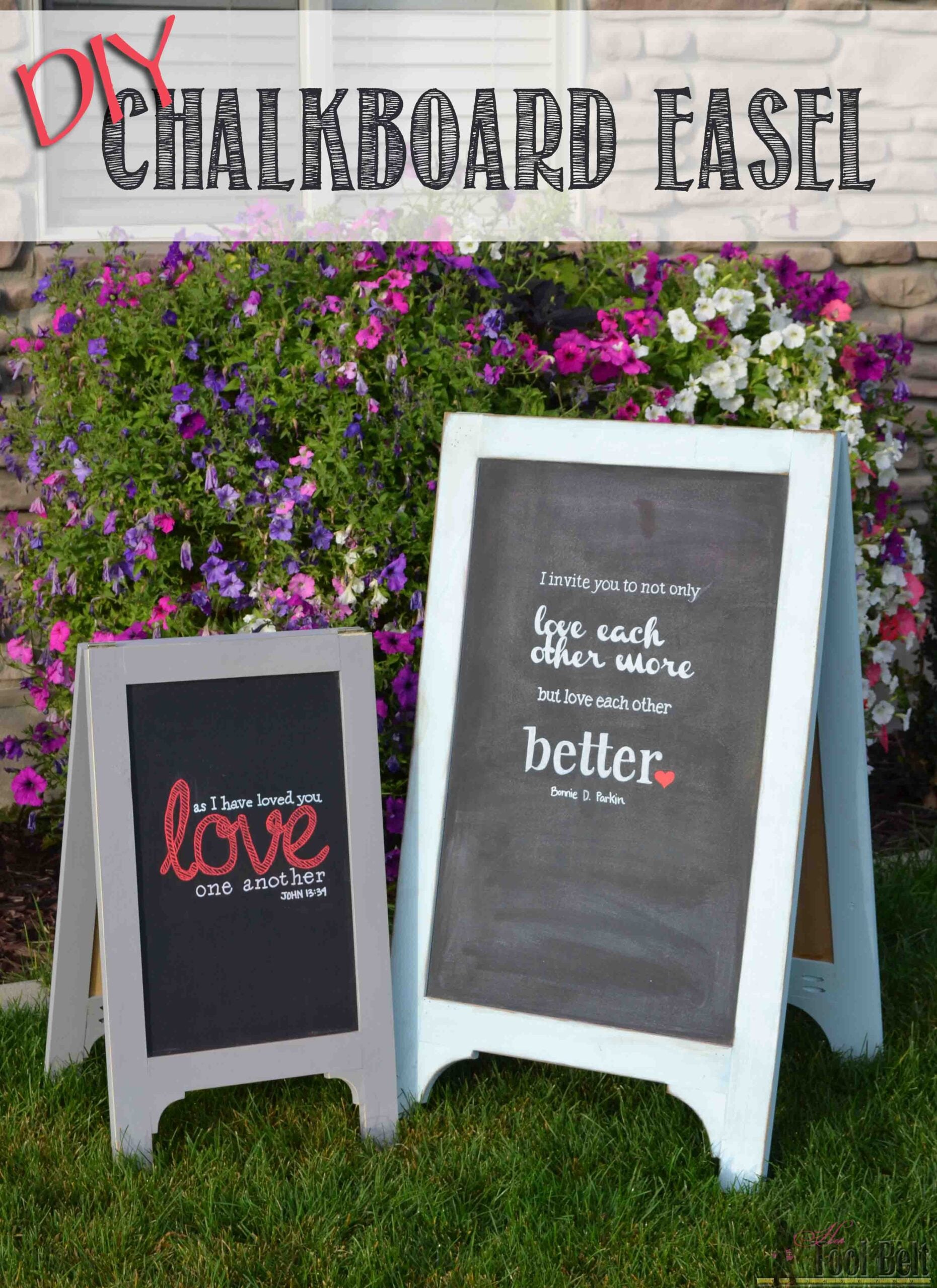 Two white A-frame chalkboard easels standing on green grass in front of petunias, each lettered with a chalk love quote