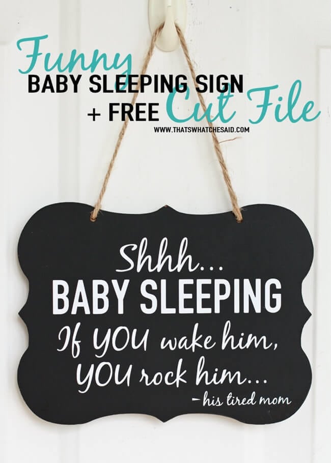 Black chalkboard sign hung on a door with jute twine reading Shhh baby sleeping, if you wake him you rock him, his tired mom