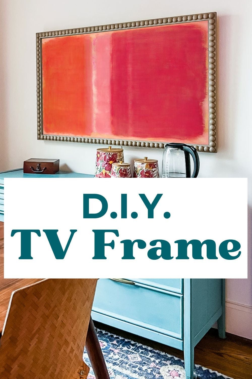 Bobbin Style TV Frame | DIY Media Room Idea Wall mounted TV framed in a beaded bobbin frame showing pink and red abstract art above a blue cabinet