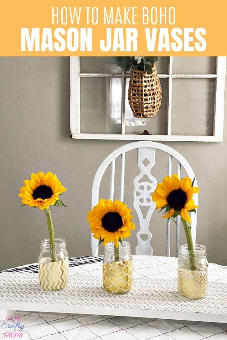Three boho decoupage mason jar vases covered in gold and white patterned paper, holding bright yellow sunflowers