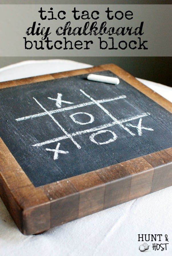 Butcher block board stained espresso with a black chalkboard center and a chalk tic tac toe game with a stick of chalk