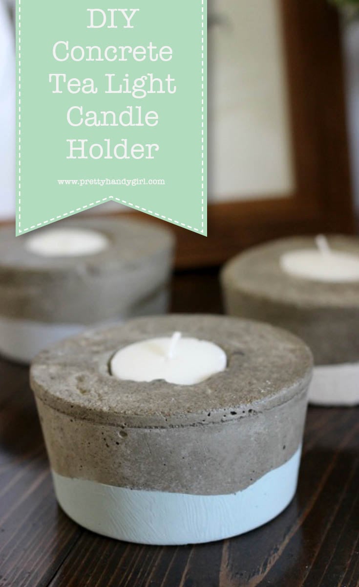 Round gray concrete tea light holders with white dipped bottoms and lit candles on a wood table, under a DIY title banner