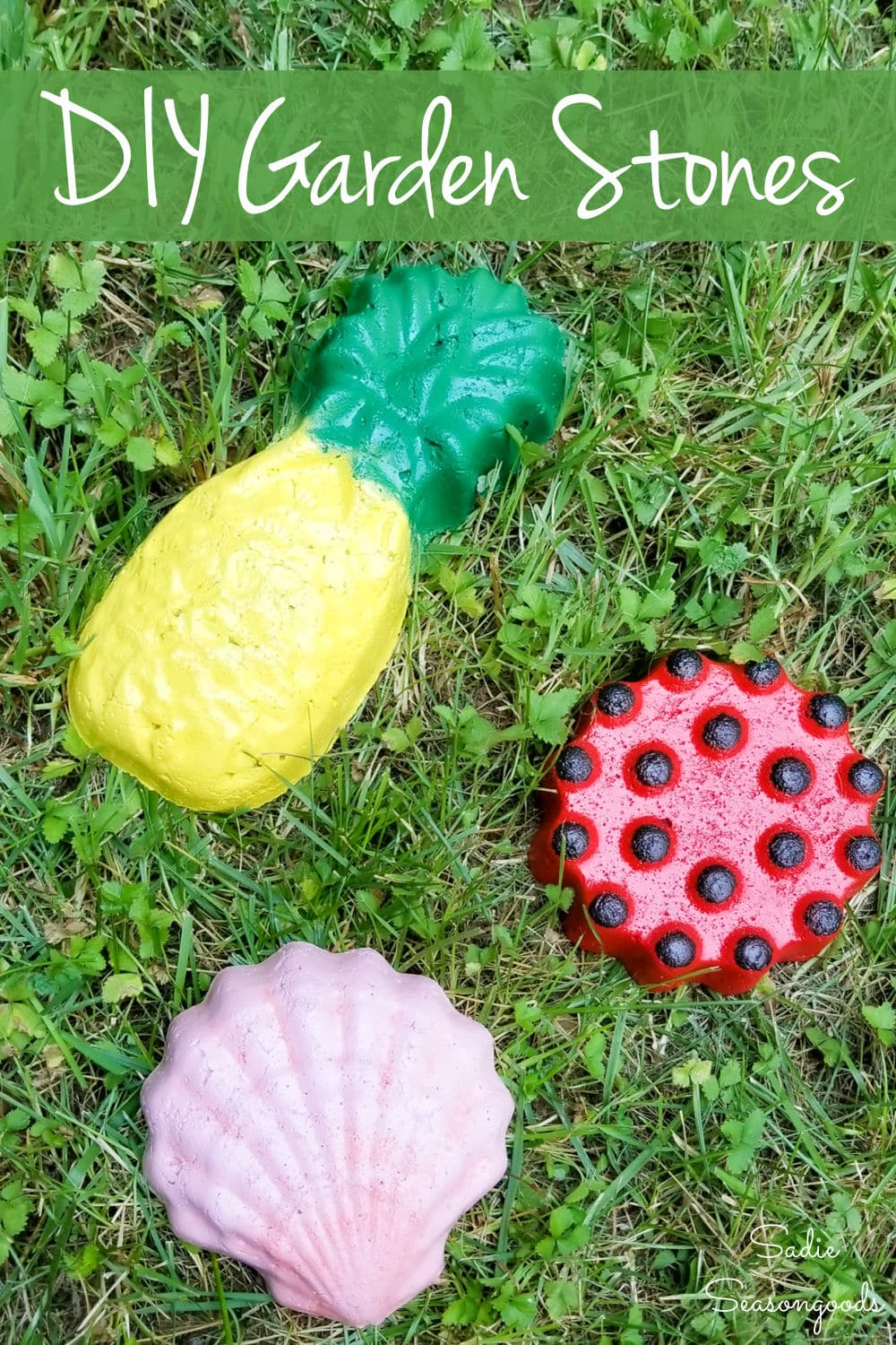 Decorative Garden Stones | Thrifted Copper Mold DIY Bright painted concrete garden stones shaped like a yellow pineapple, a pink shell and a red dotted round on grass