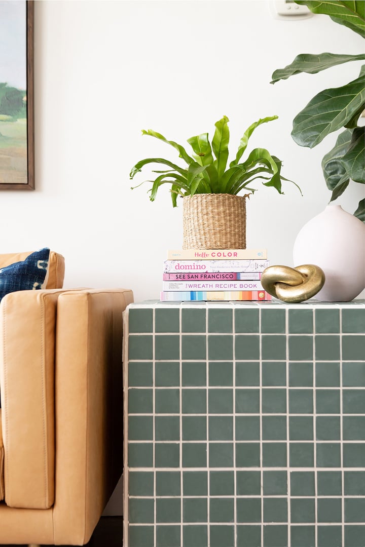 DIY Tiled Side Table | Green Square Tile Cube DIY tiled side table, a cube covered in sage green square tiles with white grout beside a tan leather sofa and a plant