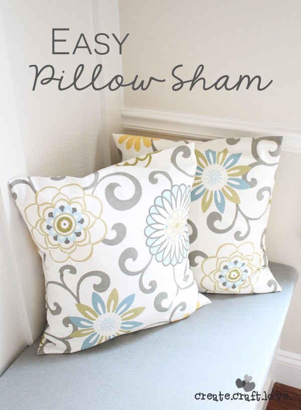 Easy Envelope Pillow Sham | Home Sewing Project Two gray, yellow and blue floral envelope pillow shams on a light blue cushioned banquette with an Easy Pillow Sham title