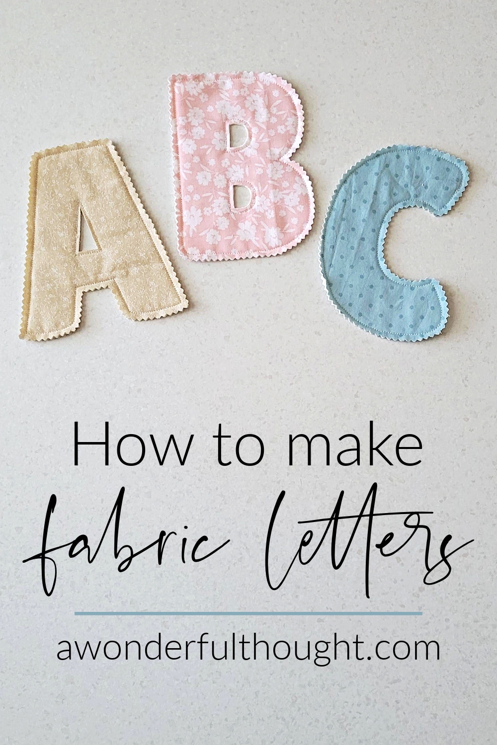 Three cut fabric letters A, B and C in tan, pink floral and blue dotted fabric with zigzag edges, lying flat on white