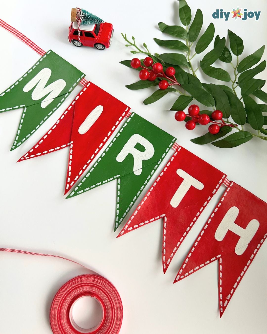Toilet paper roll Christmas banner draped as holiday decor, a cheap paper Christmas craft for a mantel, window or classroom