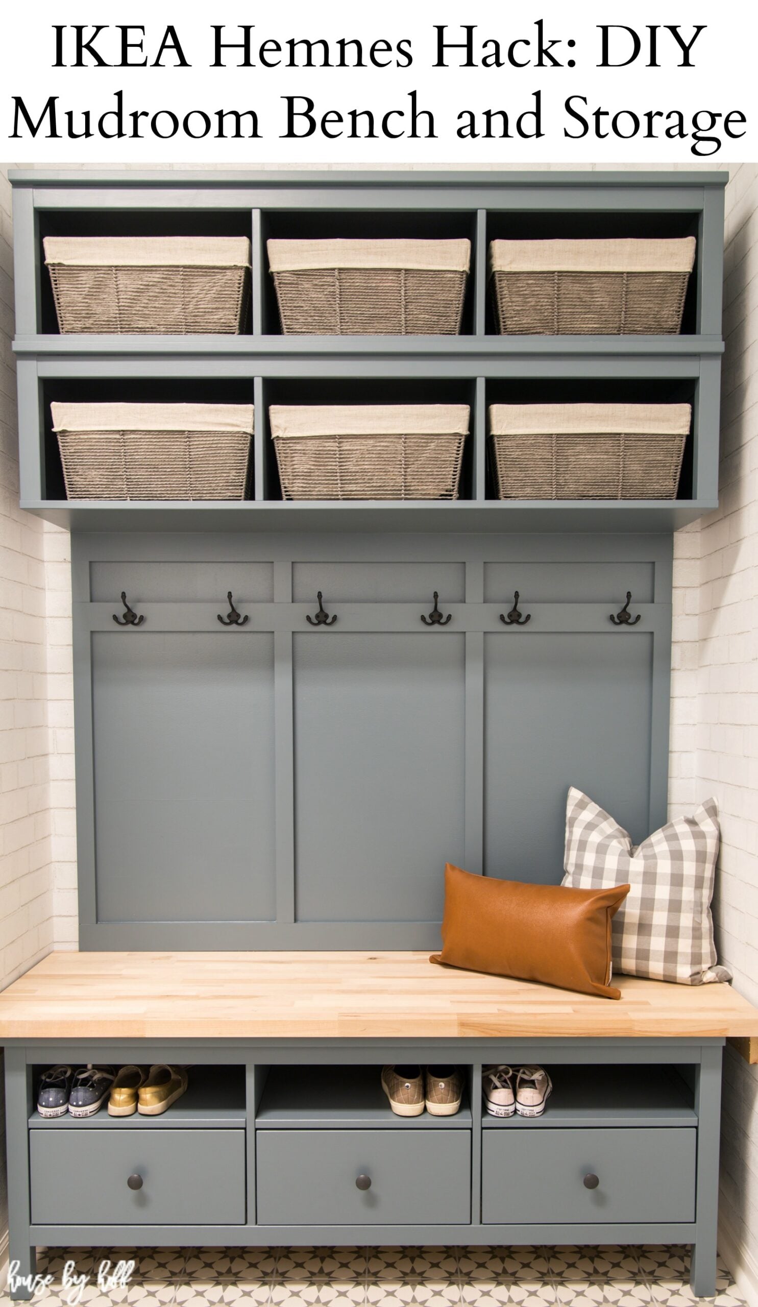 Blue-gray IKEA Hemnes mudroom bench with butcher block seat, shoe cubbies, wall hooks and woven baskets on shelves above
