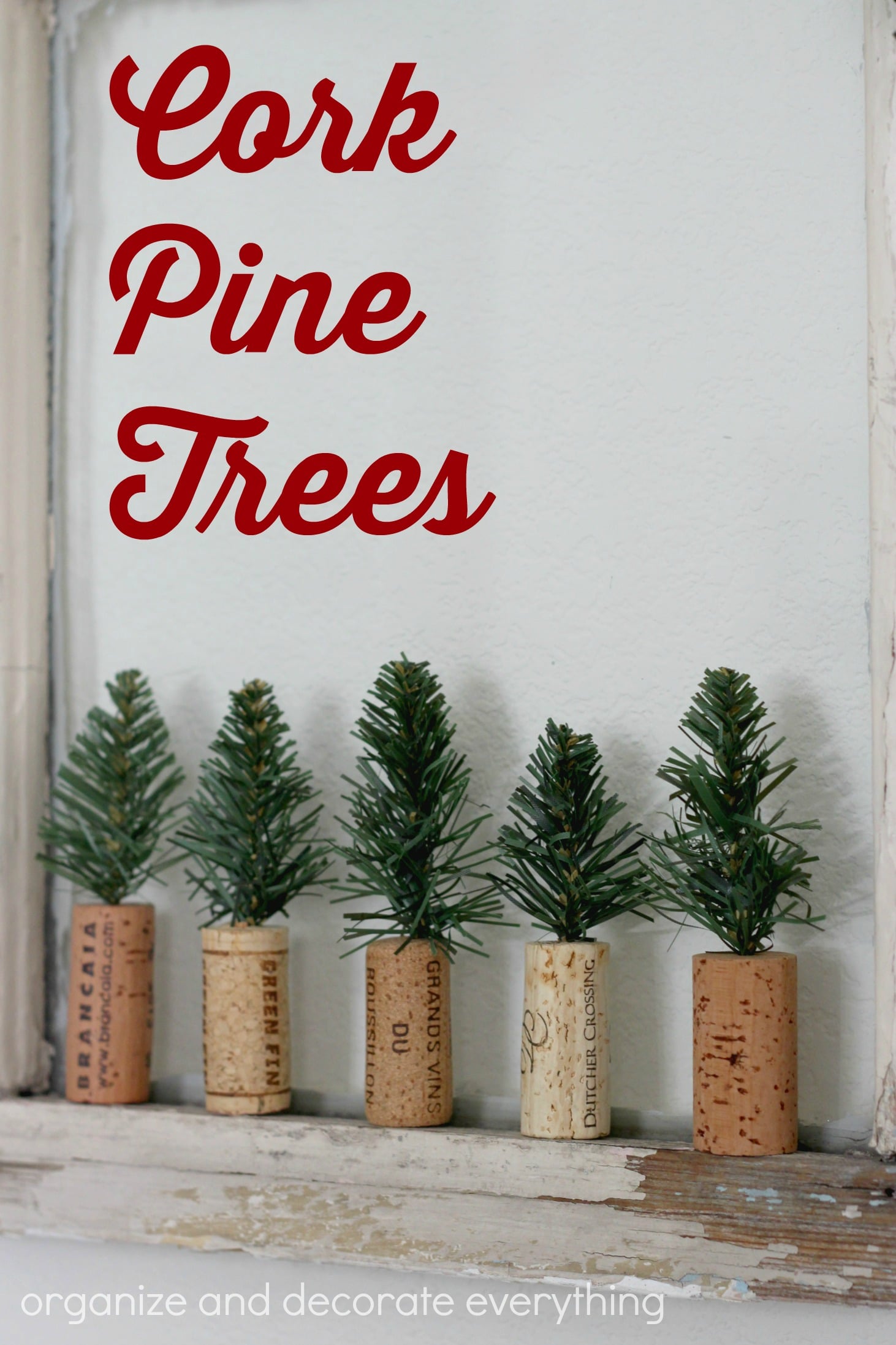 Mini cork pine trees, five small pine sprigs set into upright wine corks lined up on a white window ledge under title text