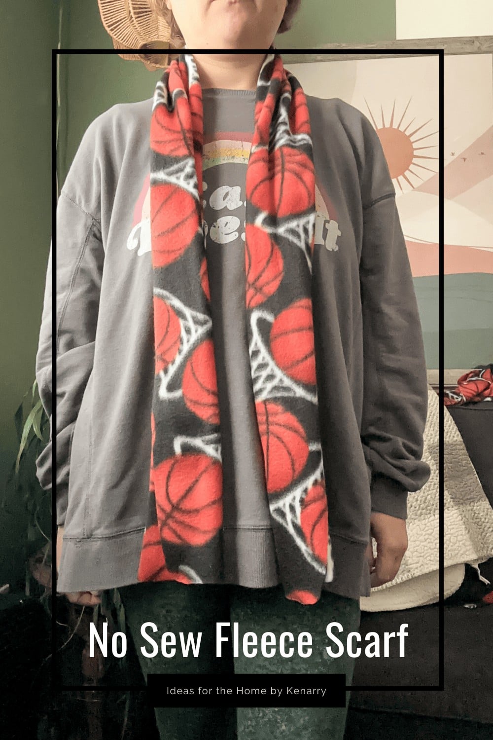 Person in a gray sweatshirt wearing a red, black and white basketball print no-sew fleece scarf with a rounded corner