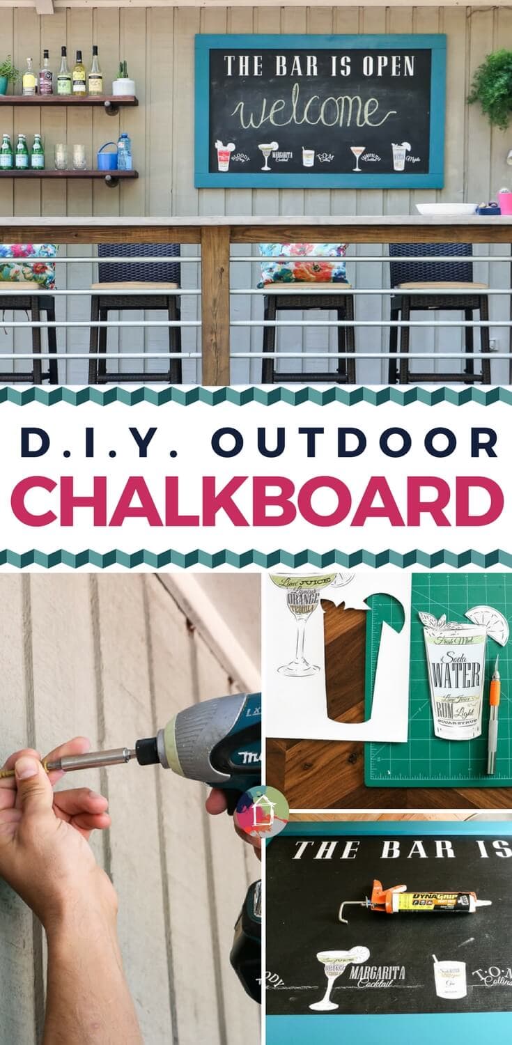 Teal framed outdoor chalkboard reading the bar is open and welcome above a wood deck bar with stools, bottles and flowers