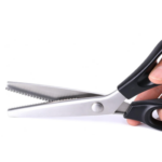 Pinking shears with black handles and zigzag blades, used to cut the fabric rectangles for the no-sew candy garland