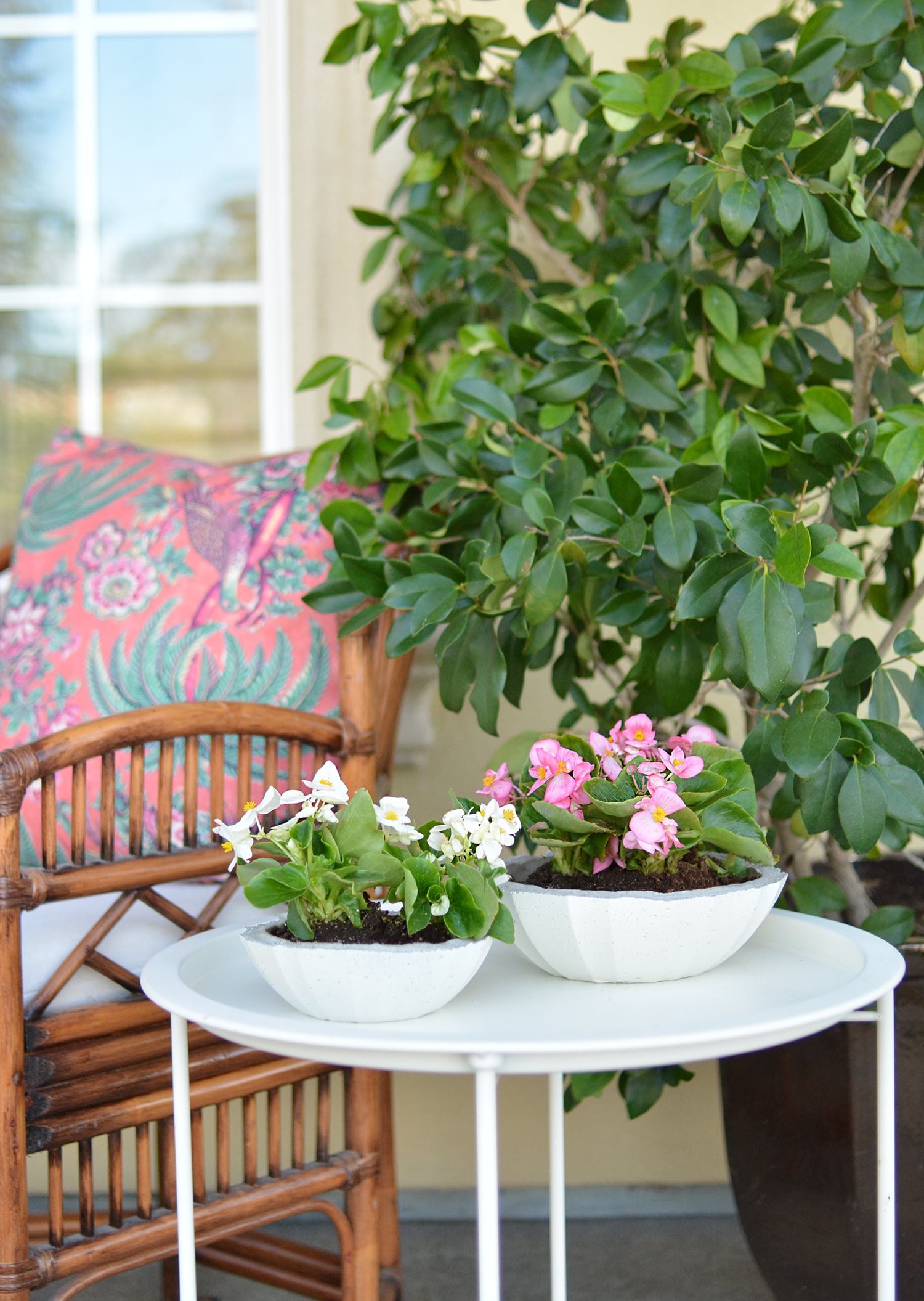 Ridged Cement Planter Bowls | Easy Porch Planters Two white ridged cement planter bowls filled with pink and white flowers on a round white table on a sunny porch