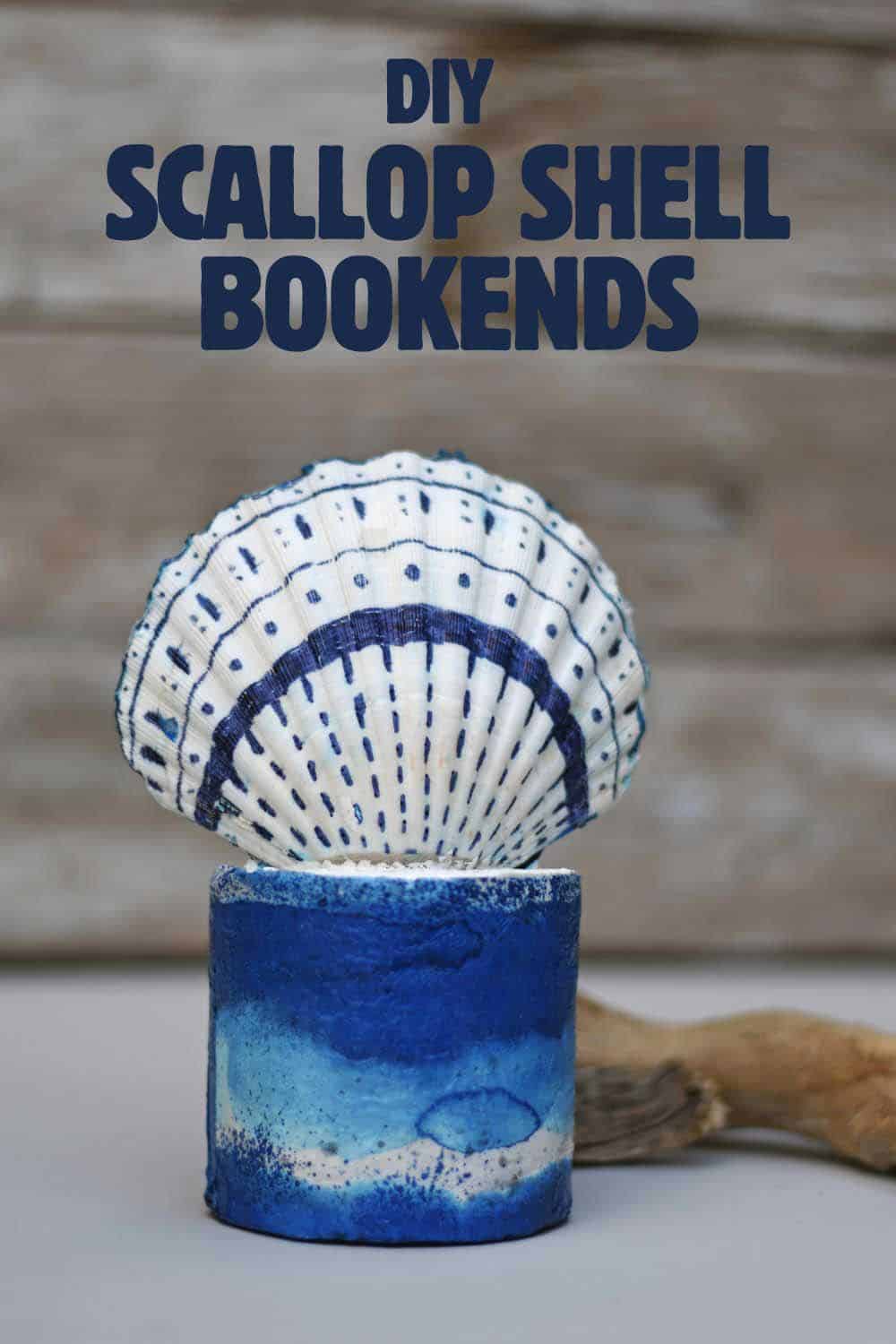 Scallop Shell Concrete Bookends | Coastal Decor DIY Scallop shell bookend with blue drawn lines standing on a round blue and white painted concrete base, under a title