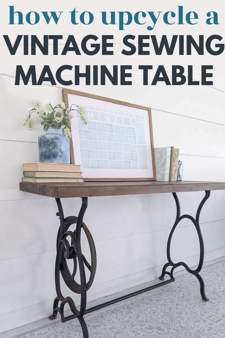 Vintage cast iron sewing machine legs topped with a walnut stained wood plank, used as a narrow desk by a white wall
