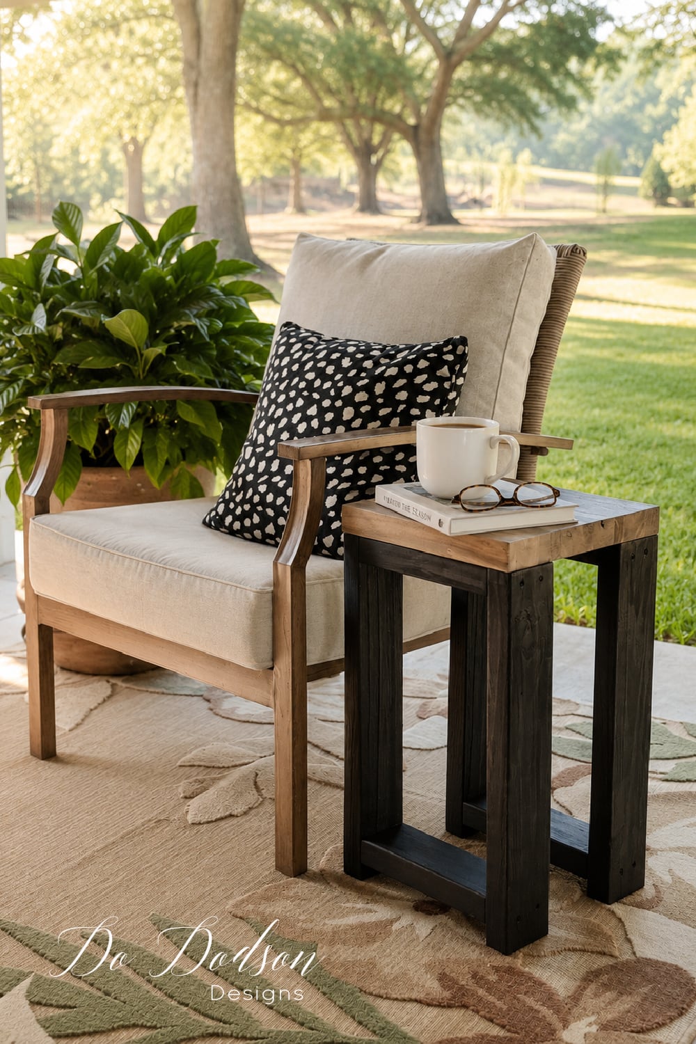Simple Outdoor Side Table | DIY Patio Furniture Idea Simple outdoor side table with a wood top and black legs beside a cushioned patio chair, holding a coffee mug and glasses