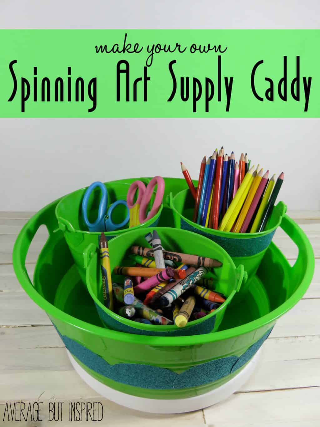 Green plastic art supply caddy with small buckets of crayons, colored pencils and scissors on a spinning lazy Susan base