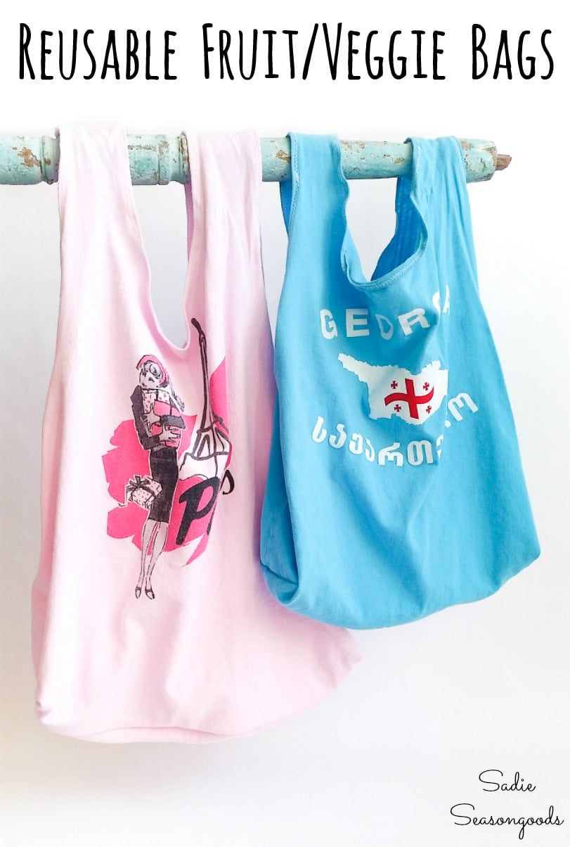 Two T-shirt produce bags in pink and aqua, sewn from thrifted kids graphic tees, hanging from a rustic painted rod