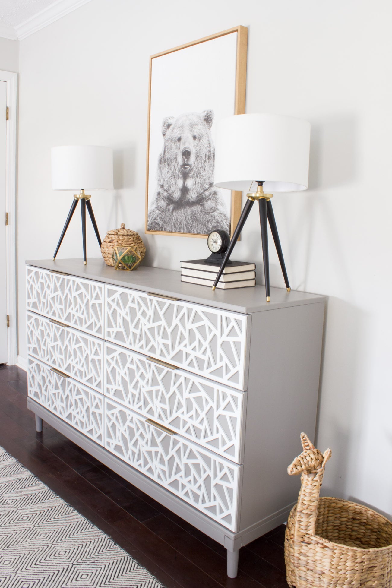 TARVA Dresser Overlay Hack | IKEA Bedroom Hack Gray IKEA Tarva six-drawer dresser with white geometric overlay drawer fronts and tapered legs below a framed bear print