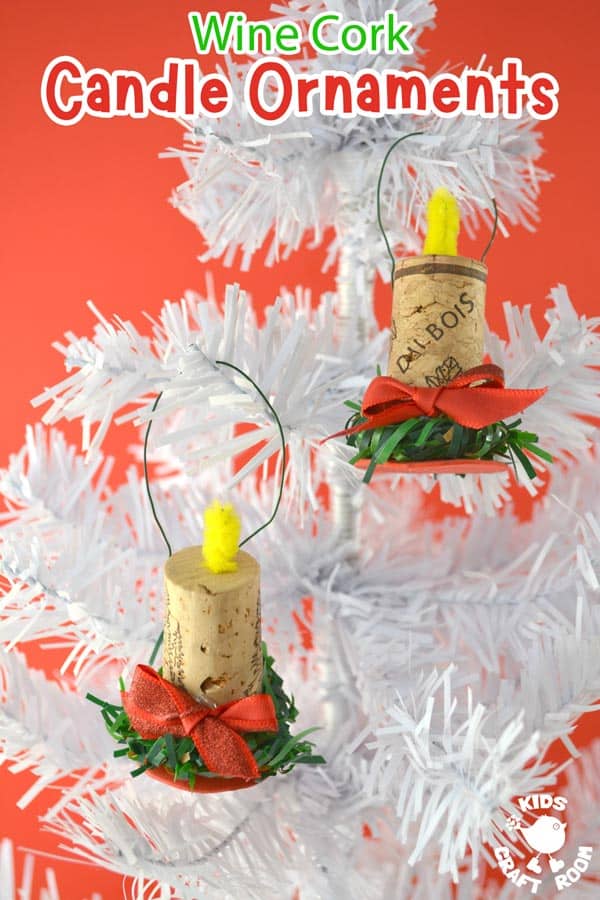 Wine cork candle ornaments with yellow pipe cleaner flames, green trim and red bows hanging on a white tinsel tree