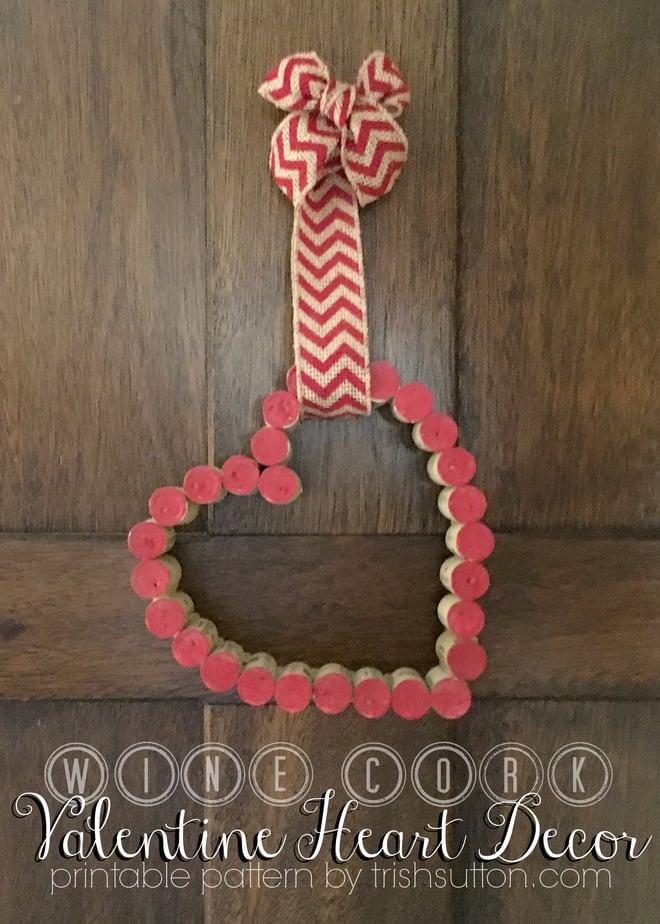 Wine cork Valentine heart decor, red painted cork ends glued into a heart hanging from a red chevron ribbon on a door